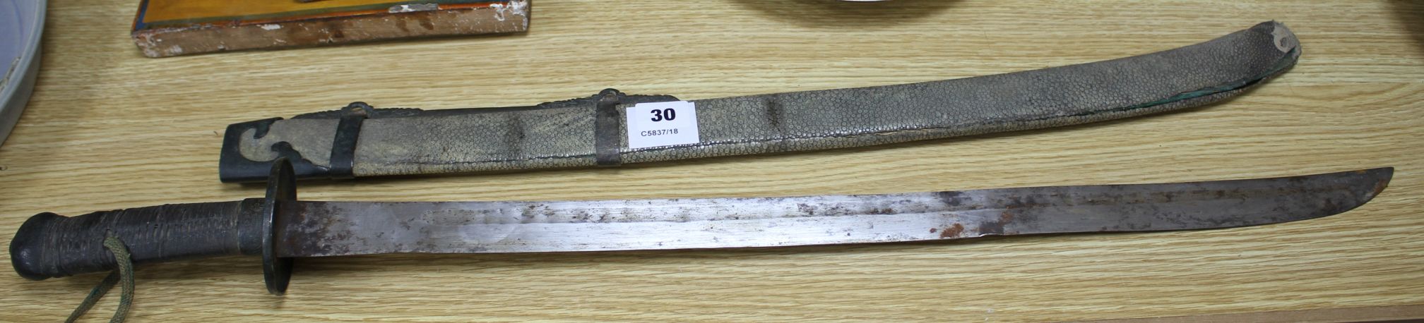 A 19th century Chinese sword, with shagreen and bronze mounted scabbard, the mounts slightly