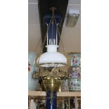 An Edwardian brass hanging oil lamp with opaque shade, overall drop 80cm Condition: Shade and flue