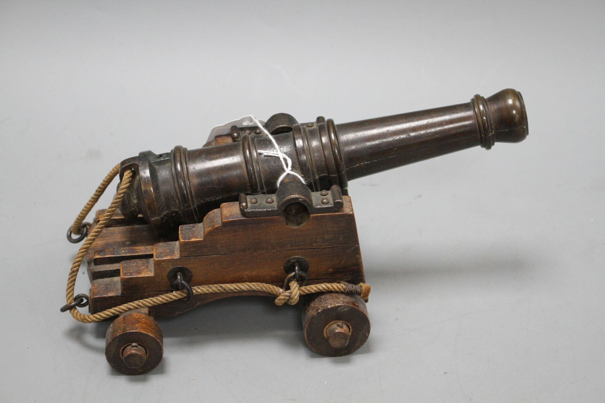 An early 20th century bronze model of a Naval cannon, on wooden trunnion base, length 25cm - Image 5 of 6