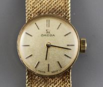 A lady's 1960's? 9ct gold Omega manual wind wristwatch, on integral textured 9ct gold Omega