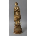 A 17th / 18th century Indo Portuguese carved and stained ivory figure of a saint, height 26cm