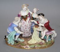 A Meissen group of an elegant lady with attendants, width 23cm, height 19cm Condition: Right hand of