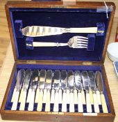 A cased set of twelve pairs of plated fish knives and forks with servers, silver banded ivorine