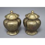 A pair of Chinese brass vases and covers, decorated with figures, cast seal marks to the bases,