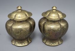 A pair of Chinese brass vases and covers, decorated with figures, cast seal marks to the bases,
