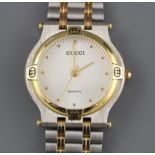 A modern stainless steel and yellow metal Gucci quartz dress wristwatch, on steel and yellow metal