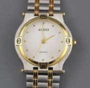 A modern stainless steel and yellow metal Gucci quartz dress wristwatch, on steel and yellow metal