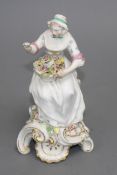 A Chelsea figure of a lady holding a flower basket, c.1765, H. 17.5cm Condition: unmarked,