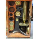 A Victorian microscope by C.C. Collins, London, in mahogany case