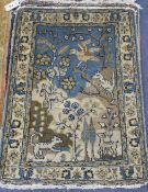 A pair of Persian blue ground small mats, decorated with animals amongst trees and flowers, and