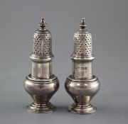 A pair of George V silver baluster pepperettes by S.W. Smith & Co, Birmingham, 1919, height 10.
