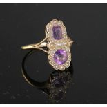 An early to mid 20th century 9ct, amethyst and seed pearl set double cluster dress ring, size O,