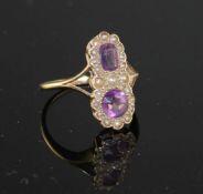 An early to mid 20th century 9ct, amethyst and seed pearl set double cluster dress ring, size O,