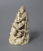 A Japanese Meiji period carved ivory group of a goddess and dragon with attendants, signed to the