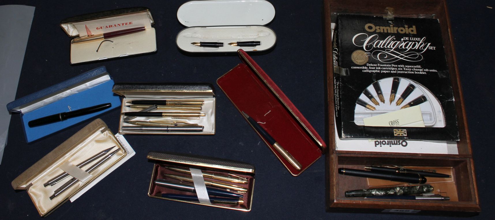 A collection of assorted pens Condition:- red cased Parker ballpoint, cap worn- black WHS tin with