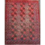 An Afghan aubergine and red ground carpet, with field of octagons and geometric motifs, 350 x