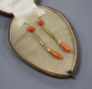 A pair of early-mid 20th century yellow metal (one stamped 15ct) and coral set drop earrings,