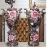 A pair of Italian floral encrusted pottery vases and covers, height 58cm Condition: Some losses to