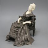 X. Raphanel. An Art Deco silvered bronze and ivory figure of an 18th century lady seated in an