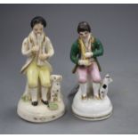 Two Staffordshire porcelain figures of musicians seated by a dog, c.1840-50, some wear to the