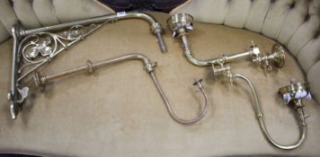 Three assorted brass gas wall light fittings and a larger drop wall light bracket Condition:- one