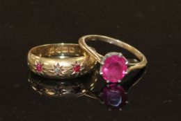 An early 20th century 18ct gold and gypsy set ruby and diamond three stone ring, size O, gross 1.9