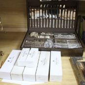 A Mappin & Webb oak cased canteen of plated flatware and cutlery for eight, with additional