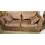 A Heals brown leather sofa, W.220cm D.94cm H.72cm Condition: The leather has marks and scratches due