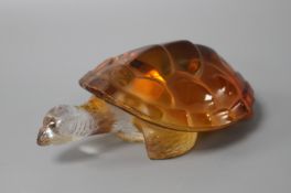 A modern Lalique amber tinted glass model of a turtle, signed with Made in France sticker, length