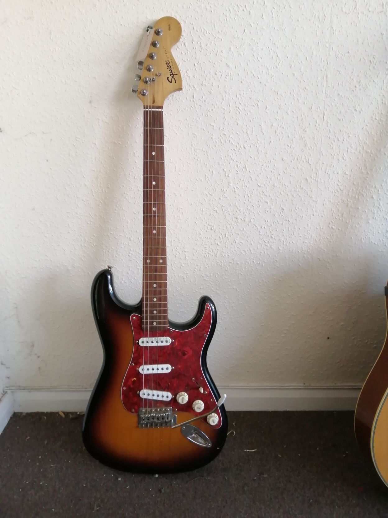 A Squier Affinity Series electric guitar Condition: Electrics are working but very large amount of