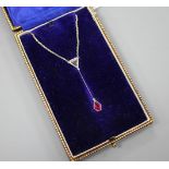 An Art Deco style white metal, ruby and diamond set drop pendant necklace, pendant section 40mm,