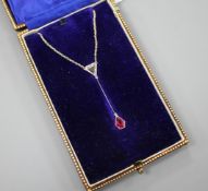 An Art Deco style white metal, ruby and diamond set drop pendant necklace, pendant section 40mm,