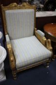 A French Empire carved giltwood armchair, W.76cm D.76cm H.116cm Condition: Seat cushion slightly