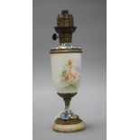 An early 20th century French champleve enamel bronze and ceramic lamp base, painted with a cherub,