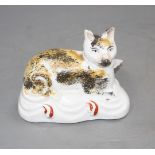 A Staffordshire porcelaneous 'flatback' figure of a recumbent cat, mid 19th century, typical minor
