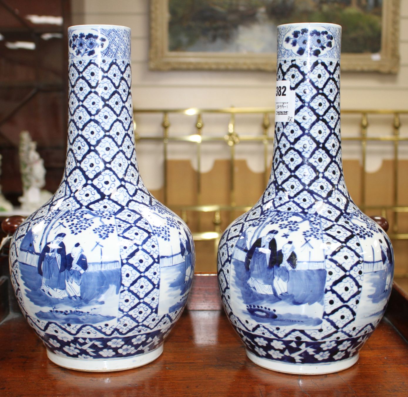 A pair of 19th century Chinese blue and white vases, decorated with panels of figures in gardens,