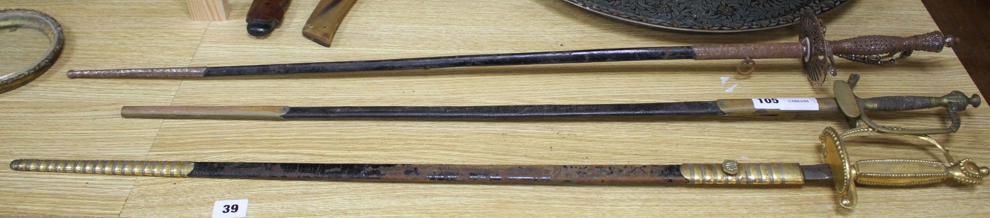 A cut steel dress sword by Ede & Ravenscroft of London and two brass hilted dress swords Condition:-