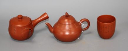 A Chinese Yixing teapot and cover, a redware teapot and cover and a cup Condition: All in very