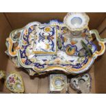 A collection of five St Malo faience dishes, a similar chamberstick, two inkwells, an unsigned oil
