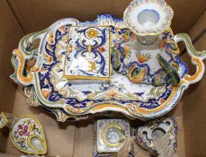 A collection of five St Malo faience dishes, a similar chamberstick, two inkwells, an unsigned oil
