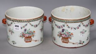 A pair of Qianlong famille rose jardinieres, of cylindrical form with mask lug handles, decorated