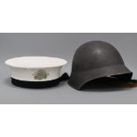 A Russian sailor's cap with numbered label and attached skull and crossbones badge, and a steel