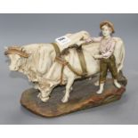 A Royal Dux group of a boy and two oxen, length 37cm