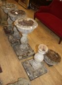 A set of four reconstituted stone pedestal garden urns, H.74cm, Diam.37cm Condition: One in need