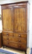 A Regency mahogany linen press with two doors enclosing five slides, two short drawers and two