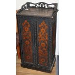 An Edwardian ebonised music cupboard, with floral pokerwork decoration, W.47cm D.35cm H.91cm