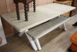 A Loaf pine extending refectory table, extended L.215.5cm W.89.5cm H.77cm, with painted X frame,