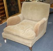 A Victorian walnut easy chair by Howard & Sons Ltd, on turned legs with brass castors (stamped),
