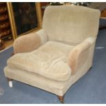 A Victorian walnut easy chair by Howard & Sons Ltd, on turned legs with brass castors (stamped),