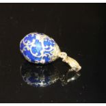 A modern 925 gilt white metal, blue enamel and diamond set egg shaped pendant, egg 20mm, gross